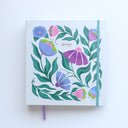 Floral notebook with purple and pink flowers on a white background