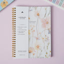 A lightweight spiral-bound planner with weekly and monthly layout, frosted softcover, and notebook style